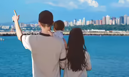 a man and woman taking a photo of the city skyline with their son