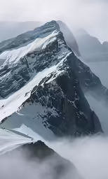an airplane flying over a large mountain peak