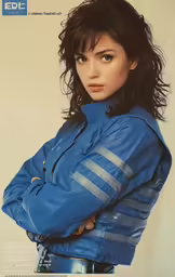 a woman poses for a photograph wearing a blue jacket