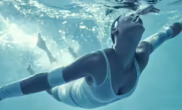 a beautiful woman swimming underwater in the ocean