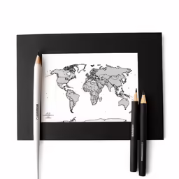 pencils sit on top of the photo, with an image of the world on it