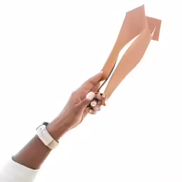 someone holding onto two long wooden utensils