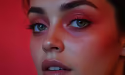 a young woman with blue eyes and orange lipstick