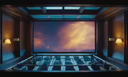 an empty cinema room filled with a big screen