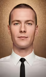 a man in a necktie in front of a metallic background