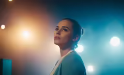 a young woman is looking at the camera