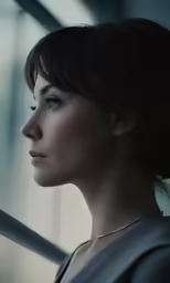 a woman looking out the window at something