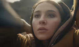 a close up of a woman with a hoodie
