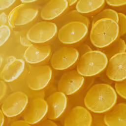 a pile of fresh sliced lemons on a counter