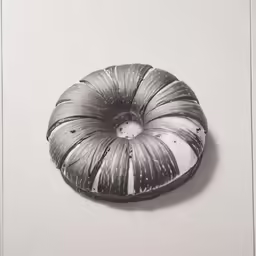 an unusual looking black and white sculpture hanging on a wall