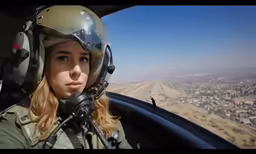 there is a female pilot that is posing for a photo