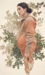 the photograph shows a woman in a hoodie holding an owl and walking on it