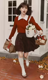 a little girl carrying bags walking down a brick road