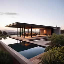 an open - concept house with an outdoor dining space and pool