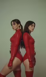 two women with very tight dresses posing for the camera