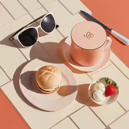 a plate that has a cookie and a cup on it
