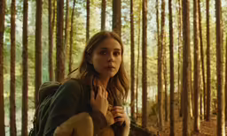 a woman standing in front of a bunch of trees