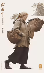 a woman walking in the snow carrying a backpack