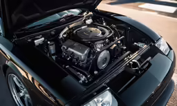 the hood and engine compartment of a black sports car