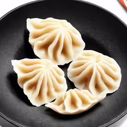 three dumplings are shown on a plate