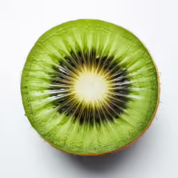 a sliced kiwi is in the middle of a white table