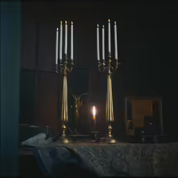 two ornate candles lit inside of a room