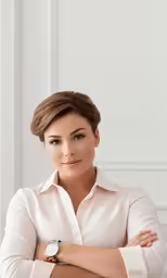 a woman is smiling in front of a wall