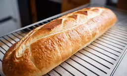 the bread is in a basket cooling on the grill