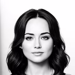 a woman in a top with her hands on her hips