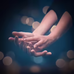 the hands of a couple are reaching for something