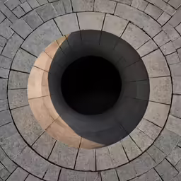 looking down at the top of a circular, brick wall