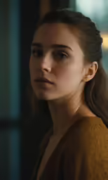a woman looking away with brown eyes