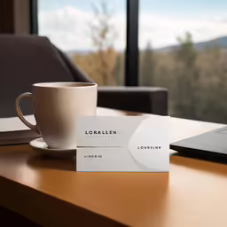 the coffee cup is next to a business card
