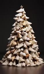 a white christmas tree made of rocks and clay