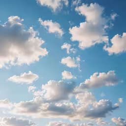 a blue sky with a few clouds and some yellow birds flying through