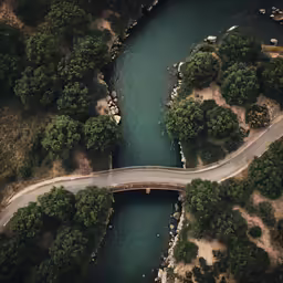 an aerial view of two curved roads going over a river