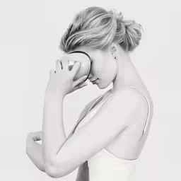 the woman is holding a bowl with her hands