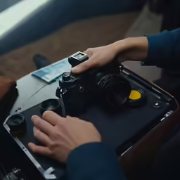 a person holding onto a camera and taking pictures