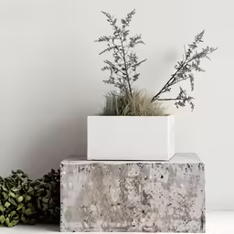three cement planters on top of each other on white surface