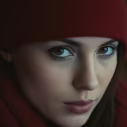 the woman is wearing a red hood and dark hair