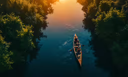 a boat on the water with a sun shining in the background