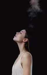 a woman in white shirt smoking cigarette