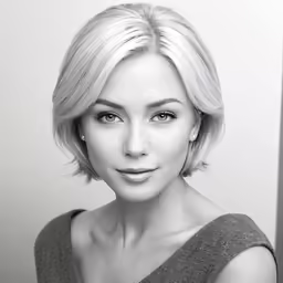 a woman with blonde hair is looking at the camera
