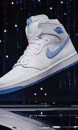 a pair of white nike sneakers with blue accents