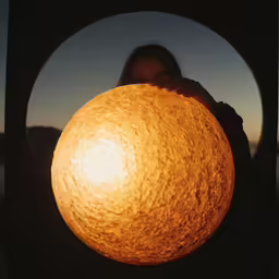 there is a woman holding a light in the frame