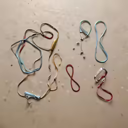 a set of four colored cords laying on a table