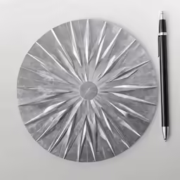a black pen sitting on top of a metal object