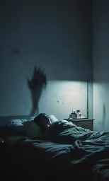 a bed with a shadow of a person leaning over the side