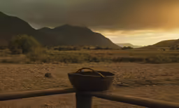 a basket that is sitting on a fence