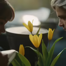 the man is giving the woman a flower vase